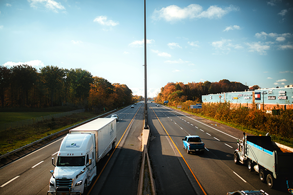An interstate with multiple semi trucks hauling loads