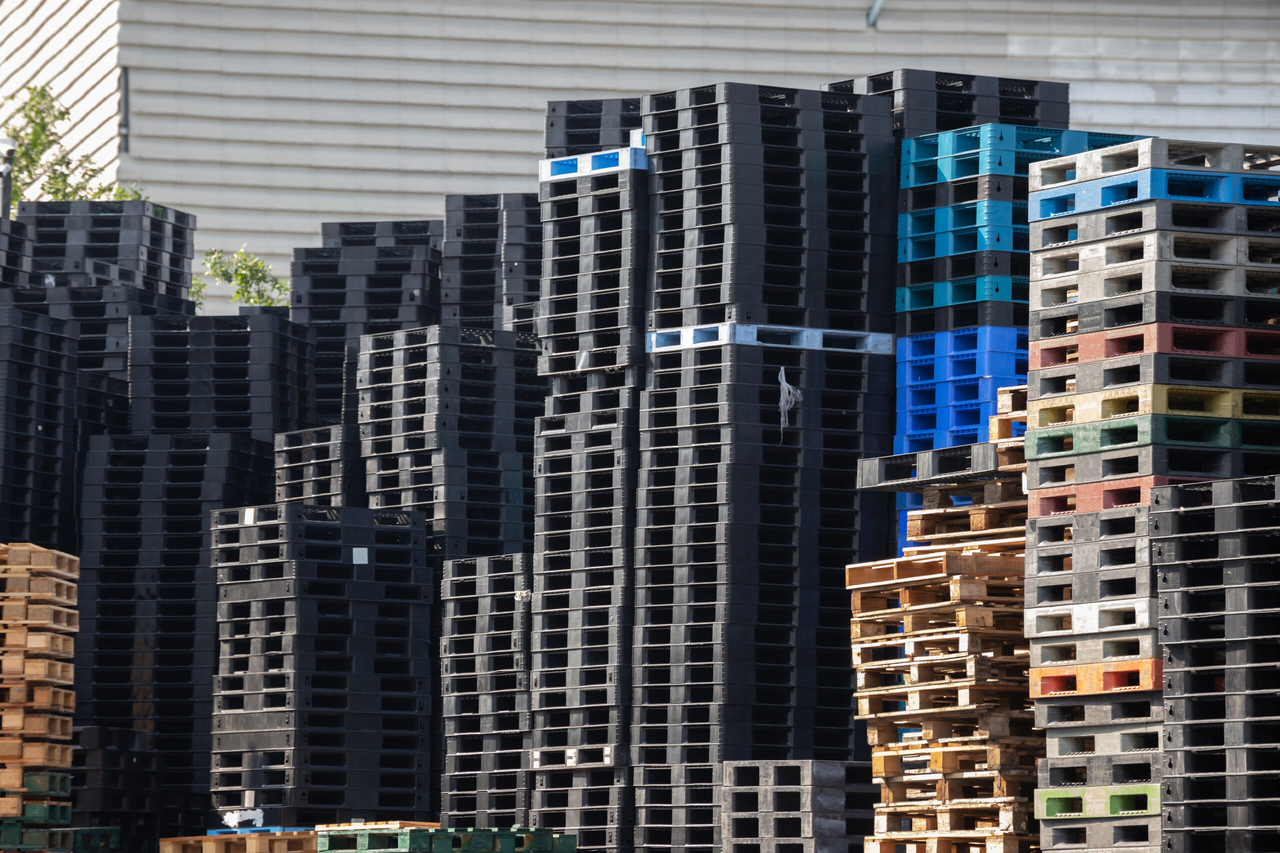 industry plastic and wooden pallets in factory yard background.